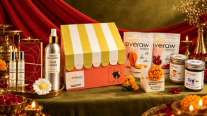 The Everaw Diwali specials on a festive table with the striped hamper box, rose water, roll-ons, bahi khata, crochet marigold, daisy candle, fruit snacks and Super Spreads