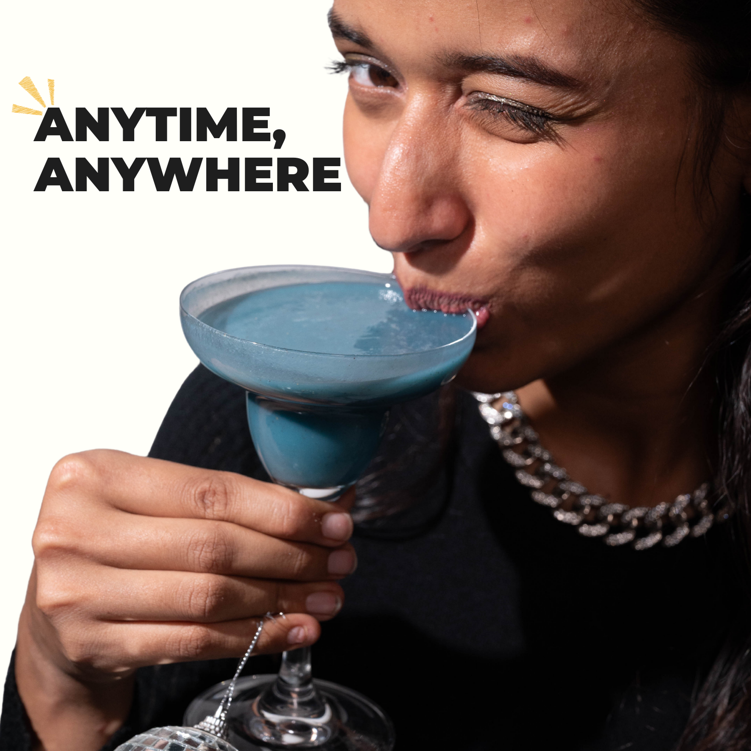 Woman drinking vivid blue smoothie - natural color from blue spirulina