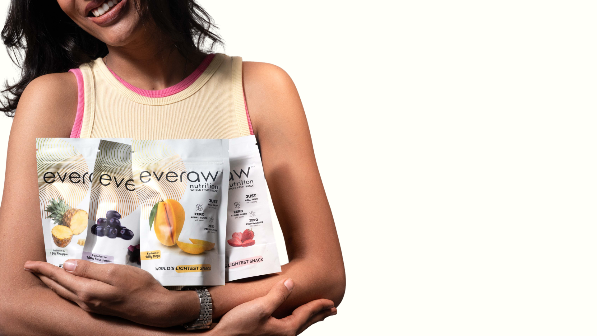 Woman holding packages of Everaw Fruit Snacks against a white background