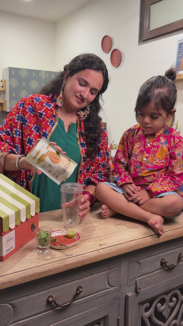 A mother and her daughter blend Everaw freeze dried mango into a mango slush and serve it in two glasses with a chilli salt rim, a Diwali party drink