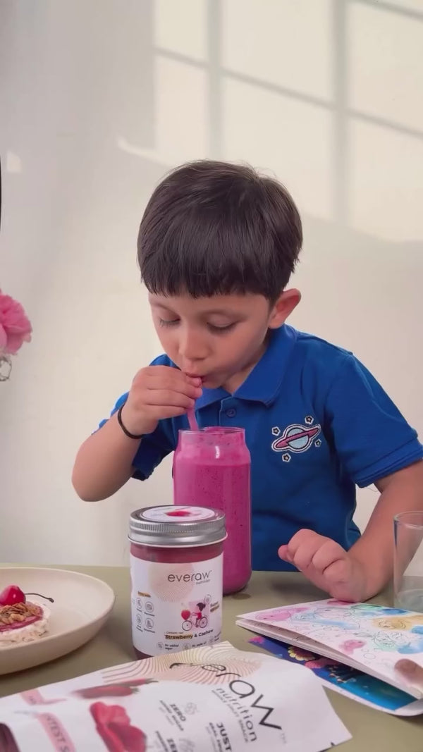 A child drinking an Everaw smoothie at the breakfast table, the reason Everaw makes real fruit nutrition for kids