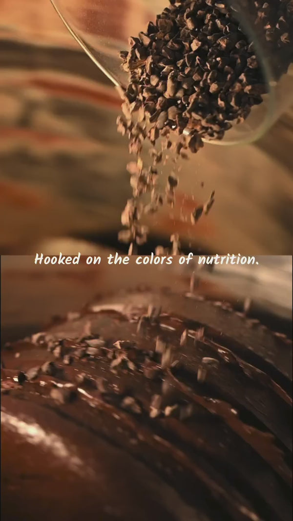 Everaw Super Spreads in cocoa almond and matcha coconut being scooped from the jar, real nut butters with no palm oil